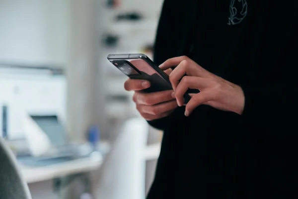 Person holding and configuring modern smartphone