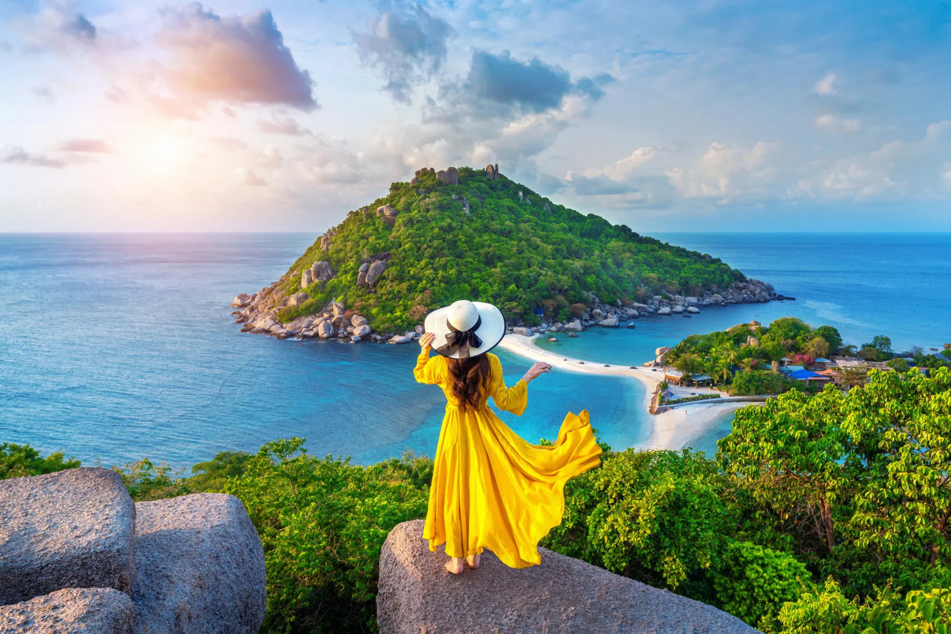 Woman overlooking tropical coastal sea with Eazy Communication eSIM