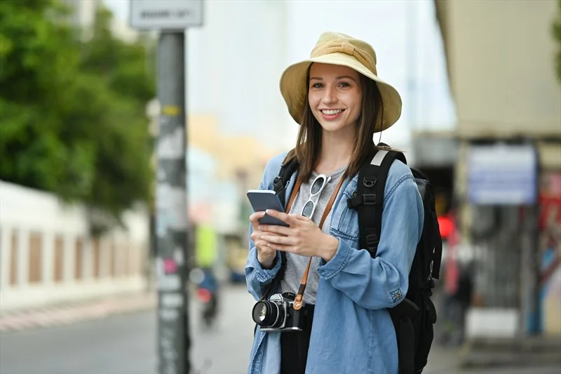 Happy traveler browsing outdoors
